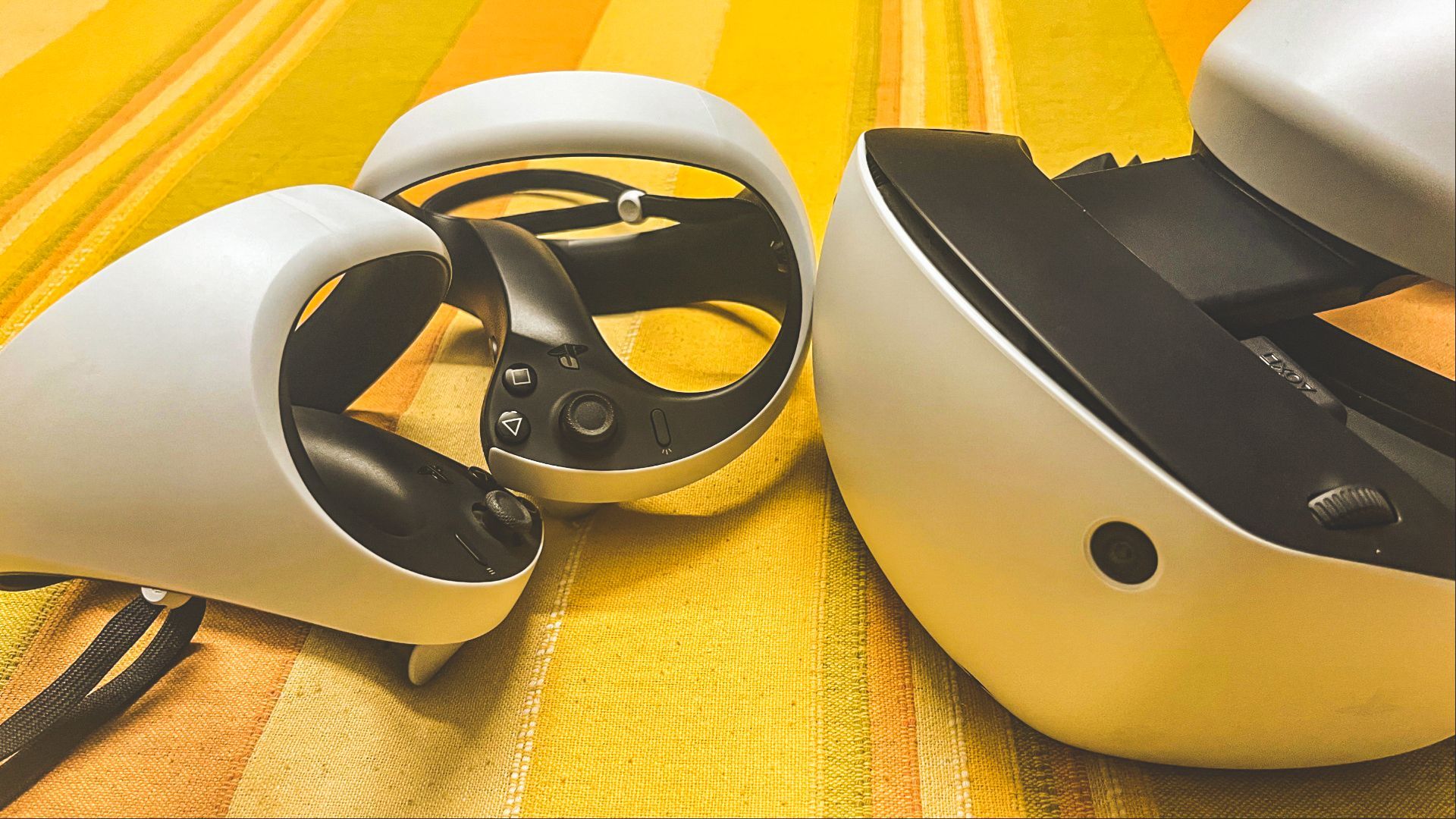 PSVR 2 headset, controllers, and earbud